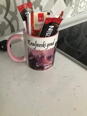 a coffee cup filled with packets of chocolate at Gracia in Jajce