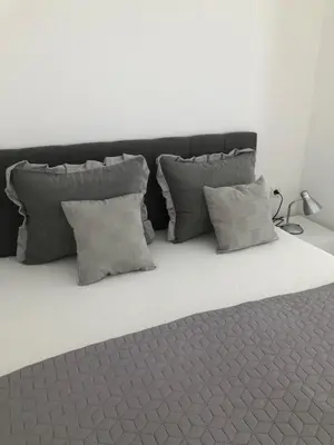 a group of pillows on a bed in a room at Gracia in Jajce