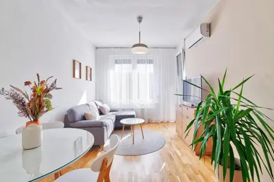 a living room with a couch and a table at GOLDENBOY apartments, Banja Luka in Banja Luka