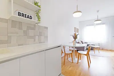 a kitchen and dining room with a table and chairs at GOLDENBOY apartments, Banja Luka in Banja Luka