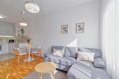 a living room with a couch and a table at GOLDENBOY apartments, Banja Luka in Banja Luka