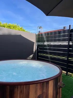 a hot tub sitting on the side of a yard at Apartment Lux Lucis in Livno
