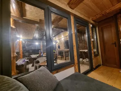 a room with windows and a couch in a house at Jajce lake cottage-Plivsko jezero in Jajce