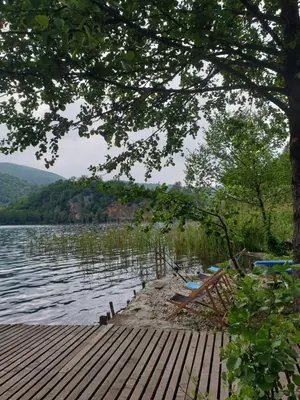 a view of a lake with a wooden dock at Jajce lake cottage-Plivsko jezero in Jajce