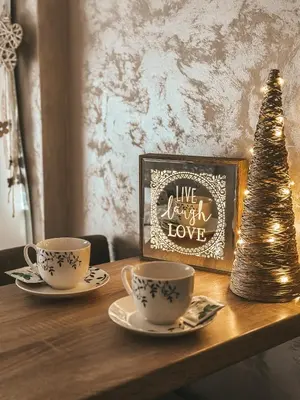 two coffee cups and a christmas tree on a table at Apartman Vila Bojana in Budžak