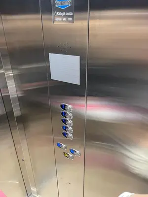 a metal refrigerator with blue buttons on it at Apartman Vila Bojana in Budžak