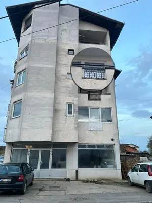 a building with a sign on the side of it at Apartman MS in Bosanska Dubica