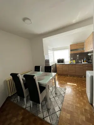 a kitchen with a table and chairs in a room at Apartman MS in Bosanska Dubica