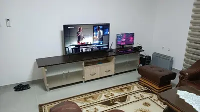 a living room with a flat screen tv on a stand at Grand Apartman in Živinice