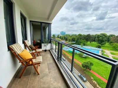 a balcony with two chairs and a view at Park & Play in Banja Luka