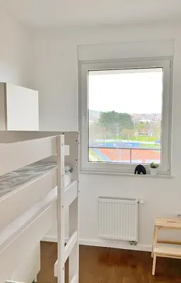 a bedroom with a bunk bed and a window at Park & Play in Banja Luka