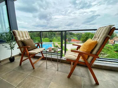 two chairs and a table on a balcony at Park & Play in Banja Luka