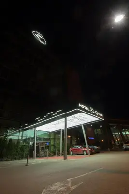 a building with a car dealership at night at Hotel Zenica in Zenica
