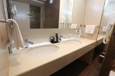 a bathroom with two sinks and a large mirror at Hotel Zenica in Zenica