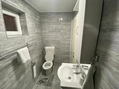 a bathroom with a toilet and a sink at Apartman Downtown in Bosanski Novi