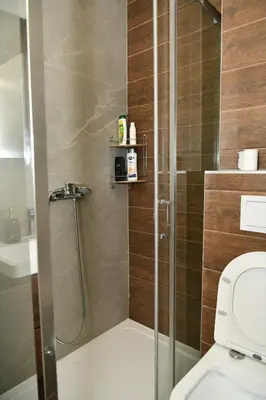 a bathroom with a shower with a toilet at Apartman Panorama Banja Luka in Banja Luka