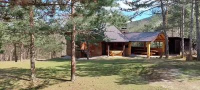 a log cabin in the woods with a yard at Naša Maša Doboj - farma jelena Nasa Masa Doboj in Doboj