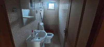 a small bathroom with a toilet and a sink at Naša Maša Doboj - farma jelena Nasa Masa Doboj in Doboj