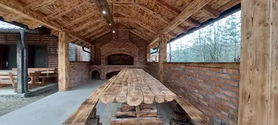 a large wooden bench sitting inside of a building at Naša Maša Doboj - farma jelena Nasa Masa Doboj in Doboj