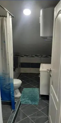 a small bathroom with a toilet and a shower at Stan Nova Varos Banjaluka in Banja Luka