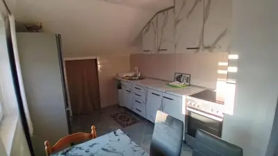 a small kitchen with white cabinets and a stove at Stan Nova Varos Banjaluka in Banja Luka