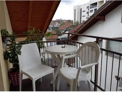a balcony with a table and two chairs on a balcony at Stan Nova Varos Banjaluka in Banja Luka