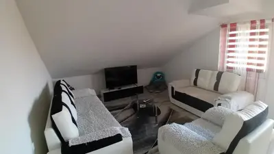 a living room with two chairs and a couch at Stan Nova Varos Banjaluka in Banja Luka