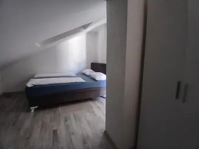 a small bedroom with a bed in a attic at Stan Nova Varos Banjaluka in Banja Luka