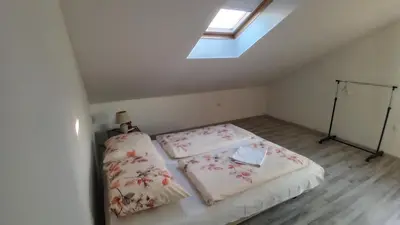 a small room with a bed and a skylight at Stan Nova Varos Banjaluka in Banja Luka