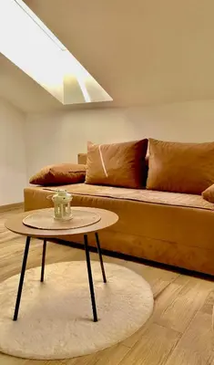 a living room with a couch and a table at Skylight studio Banja Luka in Banja Luka