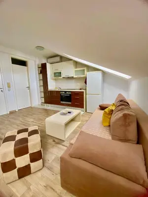 a living room with a couch and a table at Skylight studio Banja Luka in Banja Luka