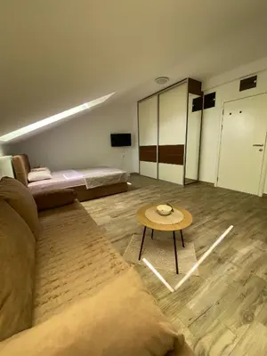 a living room with a couch and a table at Skylight studio Banja Luka in Banja Luka