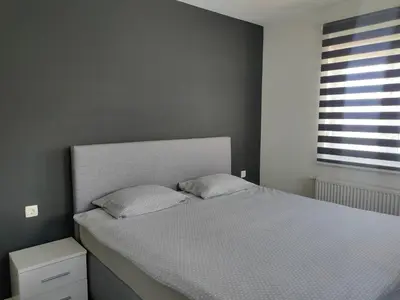 a bed with two pillows in a bedroom with a window at Apartment Maria in Tomislavgrad