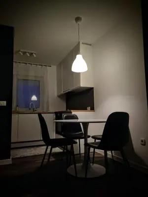 a kitchen with a table and chairs and a light at Apartment Maria in Tomislavgrad