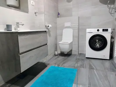 a bathroom with a washer and a washing machine at Apartment Maria in Tomislavgrad