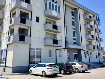 two cars parked in front of a building at Apartment Maria in Tomislavgrad