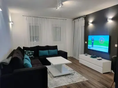 a living room with a couch and a tv at Apartment Maria in Tomislavgrad