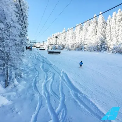 a person skiing down a snow covered ski lift at Apartman Zeko in Kupres
