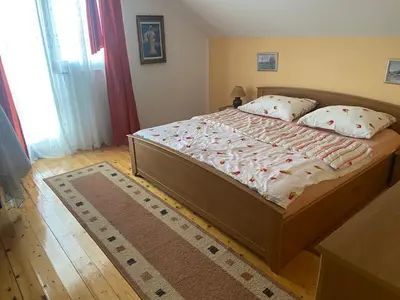 a bedroom with a large bed in a room at Apartman Zeko in Kupres