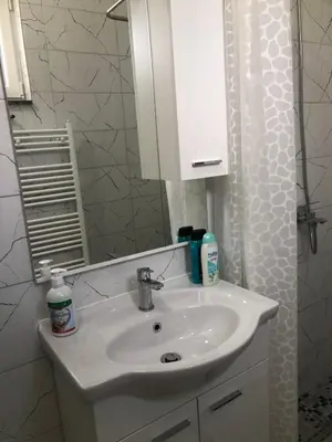 a bathroom with a white sink and a mirror at Graciaa in Jajce
