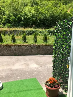 a garden with a pot of flowers and a fence at Graciaa in Jajce