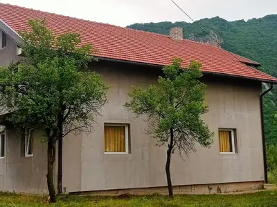 a house with two trees in front of it at Family House بيت عائلي بجميع مواصفات الراحة in Travnik
