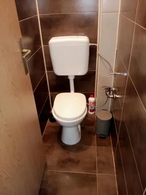 a small bathroom with a toilet in a stall at Family House بيت عائلي بجميع مواصفات الراحة in Travnik