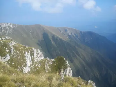 a view of a mountain with grass on it at Family House بيت عائلي بجميع مواصفات الراحة in Travnik