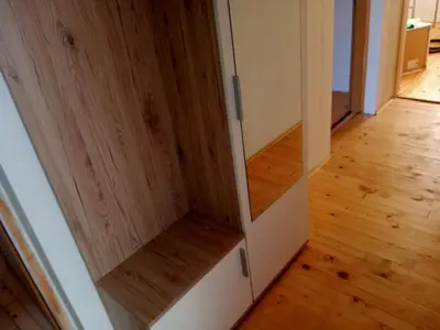 a closet with wooden doors and a wooden floor at Family House بيت عائلي بجميع مواصفات الراحة in Travnik