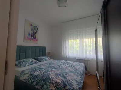 a bedroom with a bed and a window at Apartman Green City with garage in Banja Luka