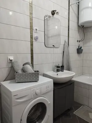 a bathroom with a washing machine and a sink at Apartman Green City with garage in Banja Luka