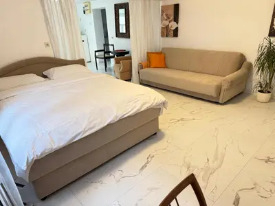 a bedroom with a bed and a couch at Apartman DIJANA BANJA LUKA in Banja Luka