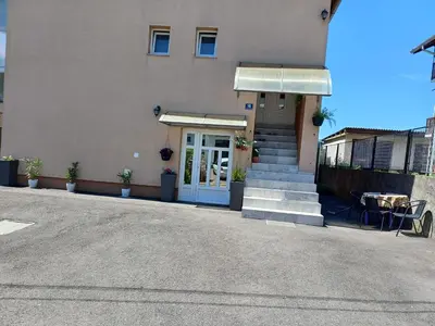 a building with a blue door and stairs in front at Apartman DIJANA BANJA LUKA in Banja Luka
