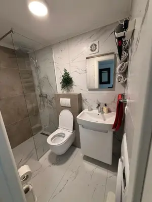 a bathroom with a toilet and a sink and a shower at Apartman DIJANA BANJA LUKA in Banja Luka